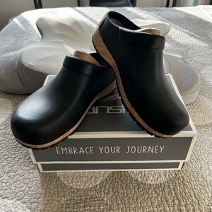Dansko Black Leather Clogs with Tan Sole